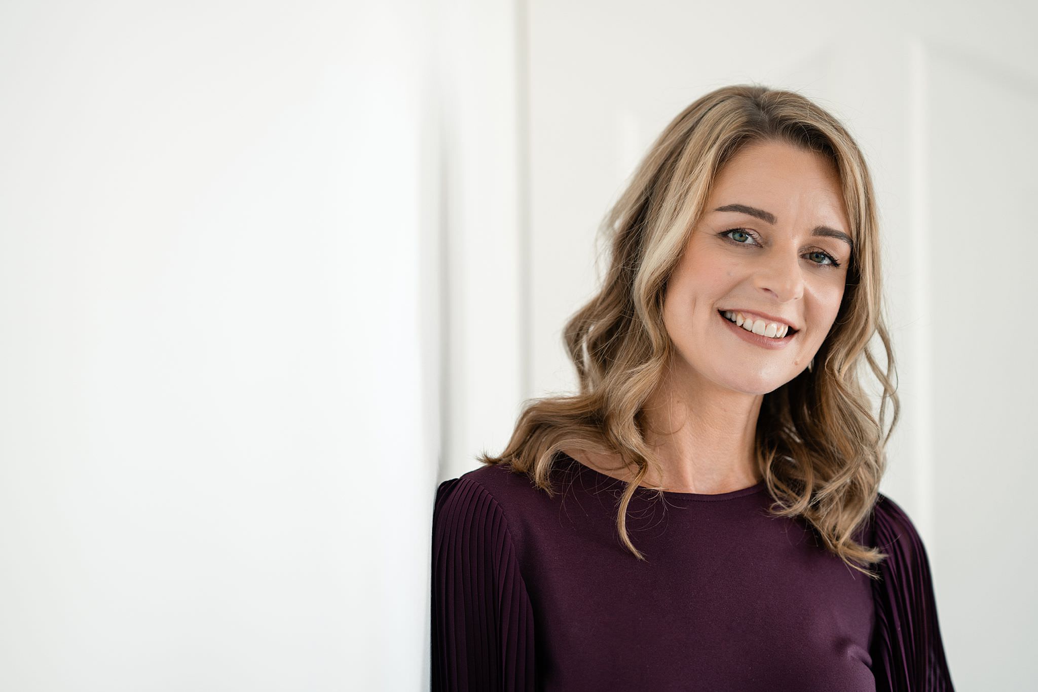 Anne Schady, coach, standing in a bright office